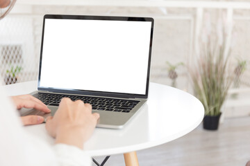 Fototapeta premium computer screen blank mockup.hand woman work using laptop with white background for advertising,contact business search information on desk at coffee shop.marketing and creative design