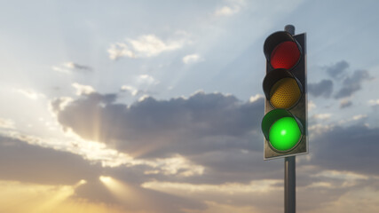 Traffic light shows green with sunset