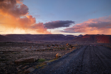 Fantastic colourful sunset near active Fagradalsfjall volcano. 4x4 car visible.