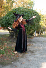 a girl with red hair in a witch costume for Halloween