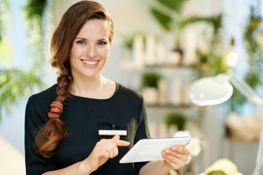 Portrait of happy female worker in modern beauty salon