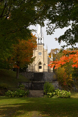 Pretty small 1879 gothic revival Notre-Dame-de-Lourdes Chapel seen in the Fall on hill dominating the St-Michel-de-Bellechasse village, Quebec, Canada