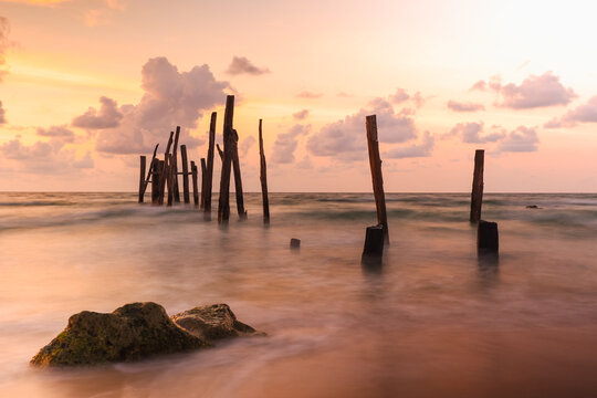 Old wooden bridge abandoned pier stumps at Thungsang bay in Chomphon province Thailand, Tropical beach seaside, White Balance effect
