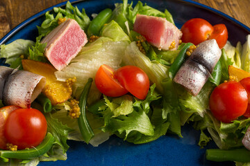 Healthy food salad with tuna and fresh vegetables closeup