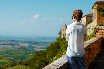 Seen from behind stylish woman in Tuscany, Italy