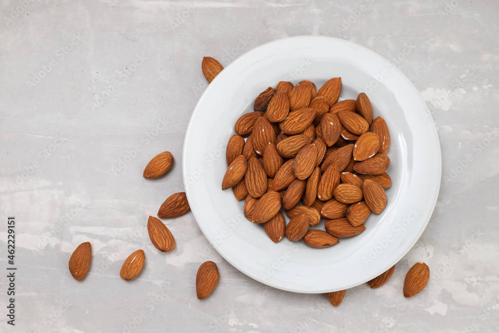 Poster almond on white small plate on ceramic