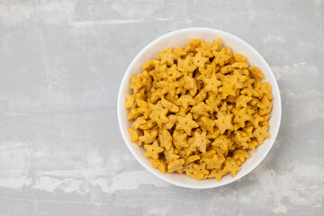 sweet yellow corn flakes in white small bowl