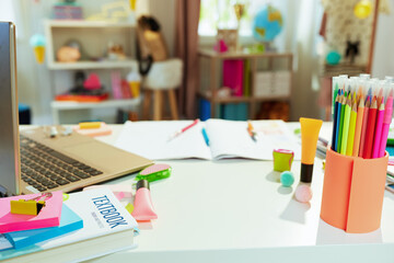 white table with workbook at school child room in sunny day