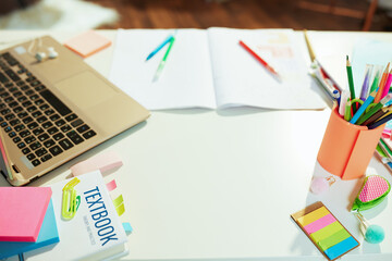 white desk with workbook at school child room in sunny day