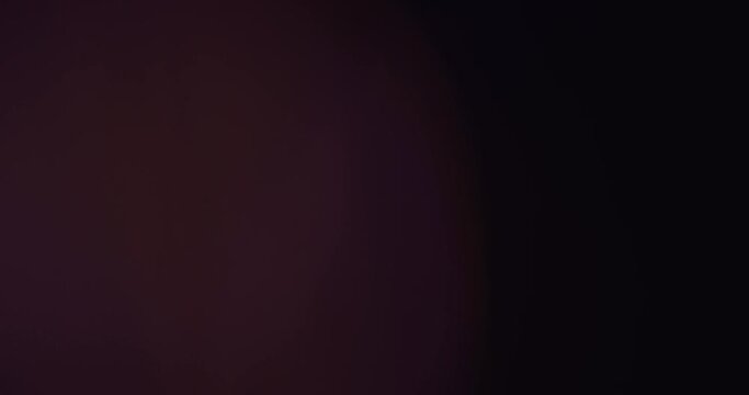Motion of Colorful Bokeh Lights Rays on Black Background. Lamp Rays Lens Flare Effect Compositing. 4K Resolution. Using for Music Backgrounds. Wallpaper. Movable Screensaver. Blue. Pink. Orange.