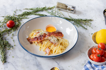 Spaghetti Carbonara: A culinary masterpiece showcasing classic spaghetti carbonara, adorned with perfectly cooked pasta, crispy bacon, a luscious egg yolk, and a sprinkle of grated cheese.