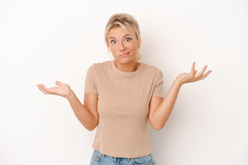Young Russian woman isolated on white background doubting and shrugging shoulders in questioning...