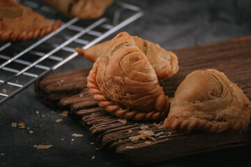 Delicious homemade curry puff on dark background.