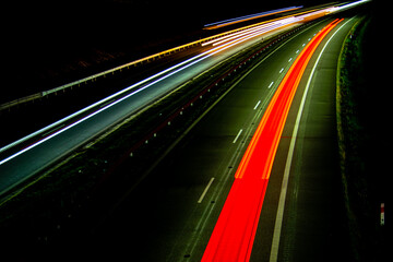 Night road lights. Lights of moving cars at night. long exposure red, blue, green, orange.