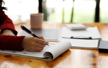 Fototapeta premium Close up of Businesswoman hands hold documents with financial statistic stock photo,discussion and analysis data the charts and graphs. report Finance concept