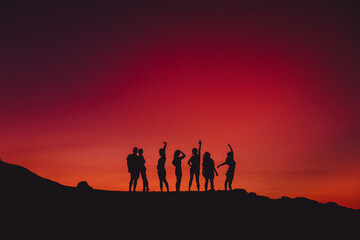 Sky with sunset or sunrise and silhouette of group people