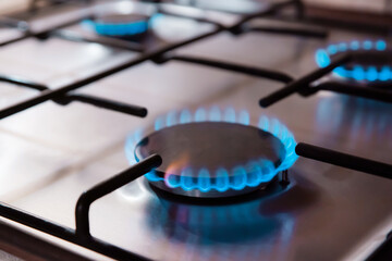 Kitchen stove cook with blue flames burning