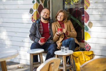 man and a woman in a cafe drinking coffee