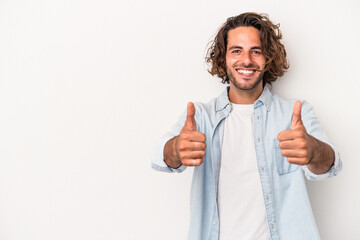 Young caucasian man isolated on white background smiling and raising thumb up