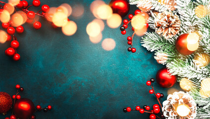 Blue Christmas or New Year background with red Christmas balls, berries, fir branches, pine cones...
