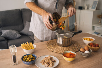 man with vitiligo making pasta for a salad
