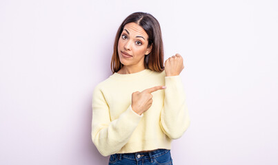 pretty hispanic woman looking impatient and angry, pointing at watch, asking for punctuality, wants to be on time