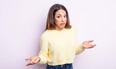 pretty hispanic woman feeling clueless and confused, having no idea, absolutely puzzled with a dumb...