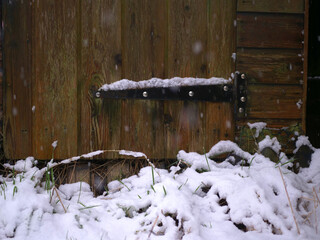 Rustic old wooden shed as snow falls in winter - Powered by Adobe