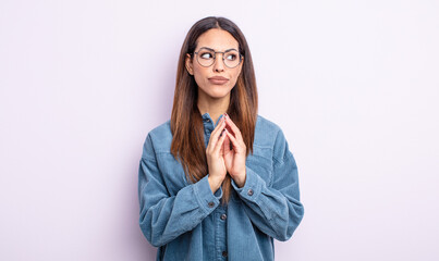 pretty hispanic woman scheming and conspiring, thinking devious tricks and cheats, cunning and...