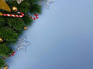 Christmas decorations, pine tree leaves, golden balls, snowflakes, golden berries on blue background