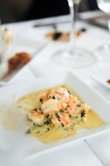 Shrimps with cream sauce and herbs