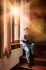 Portrait of young businesswoman with notebook and phone at window