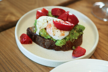 Benedict eggs with tomato and avocado