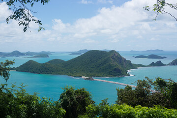 Obraz premium Panoramic view with island on blue sky and clouds