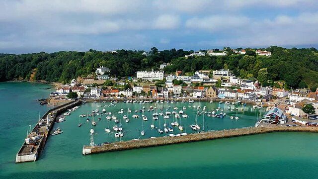 Aerial video of St Aubin's Harbour at high tide with St Aubin's village in the background, Jersey, Channel Islands