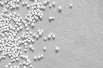 Fototapeta premium Abstract minimal background in gray with white spheres and copy space. Pattern with textured concrete surface and balls.