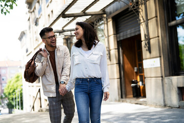 Happy young couple outdoors. Loving couple walking in the city