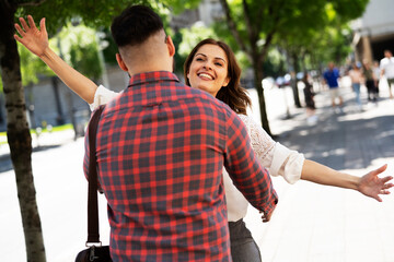 Happy young couple in the city. Loving couple hugging outdoors.