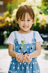 Cute kid planting a tree for help to prevent global warming or climate change and save the earth....
