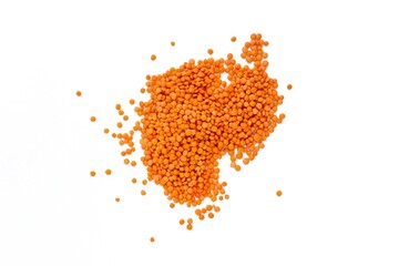 Red lentil, top view of raw red lentil grains on isolated white background.