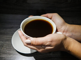 girl holding a coffee in her hands, coffee drink, cup of coffee, morning breakfast