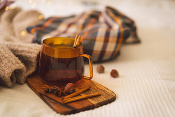 Still life details in home interior. Sweaters and cup of tea with autumn decor and books. Read, Rest. Cozy autumn concept.