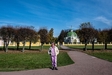 woman in pink against the background of the old museum and park complex Kuskovo in Moscow in the...
