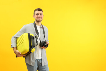 Traveling concept with young man on yellow background, space for text