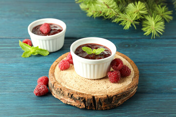 Concept of tasty food with raspberry jam on wooden background