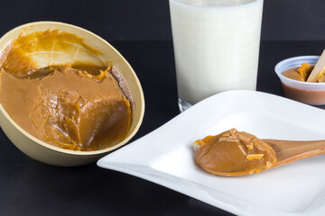 Traditional Christmas dulce de leche from the Valle del Cauca region of Colombia called Dulce de Manjar Blanco packaged in a container of plant origin fruit of the totumo tree