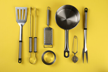 Kitchen utensil on yellow background, top view