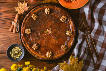 Fresh Pumpkin pie on wooden background top view