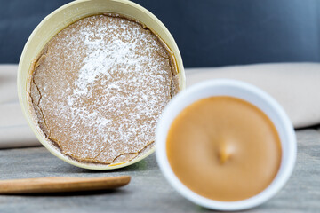 Traditional Christmas dulce de leche from the Valle del Cauca region of Colombia called Dulce de Manjar Blanco packaged in a container of plant origin fruit of the totumo tree