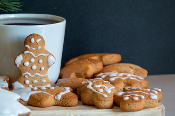 Happy New Year's set of gingerbread from ginger biscuits glazed sugar icing decoration on black background, minimal seasonal pandemic winter holiday banner